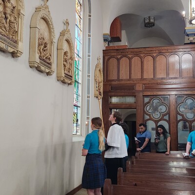 Students lead the stations of the cross during the Lenten season